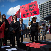 A protest against domestic violence as part of a nationwide strike, in Tel Aviv, December 4, 2018. The sign reads: 'Electronic tracking [of offenders] saves lives.' (Miriam Alster/Flash90)
