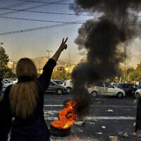 Iranians woman protests a 22-year-old woman Mahsa Amini's death after she was detained by the morality police, in Tehran, October 1, 2022. (AP Photo/Middle East Images)