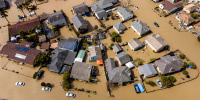 Floodwaters surround homes and vehicles in Monterey County, Calif.