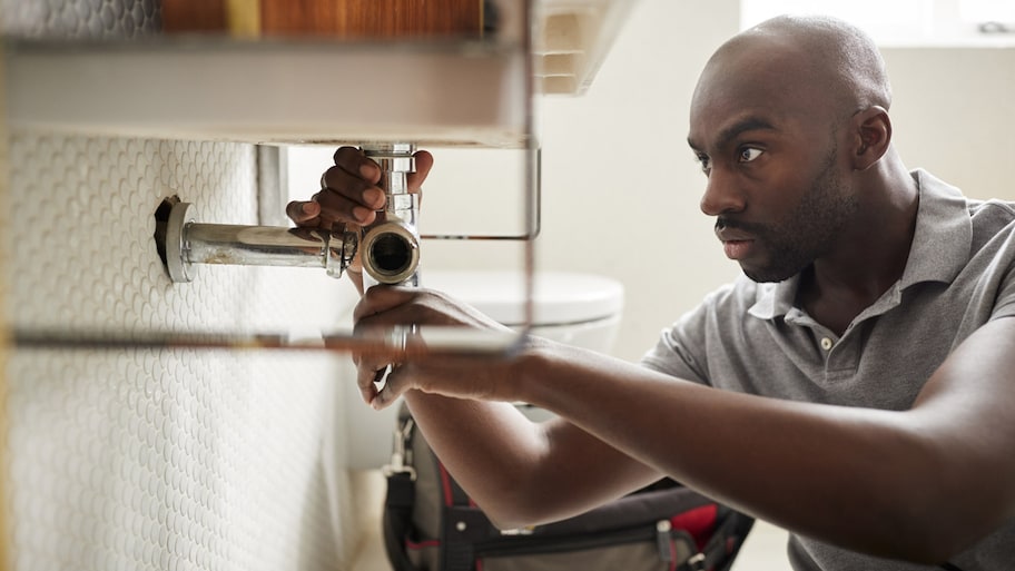 Plumber fixing a bathroom sink