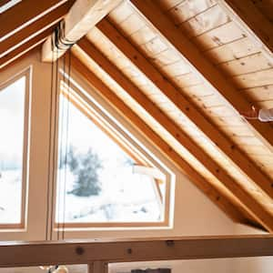 Mom and daughter looks out window of vaulted ceiling