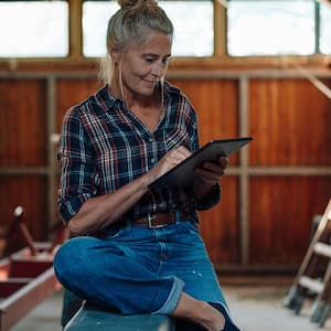 Woman planning on ipad in the garage.