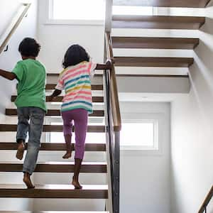 Two children walk up stairs