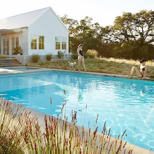 Two women and dog backyard pool