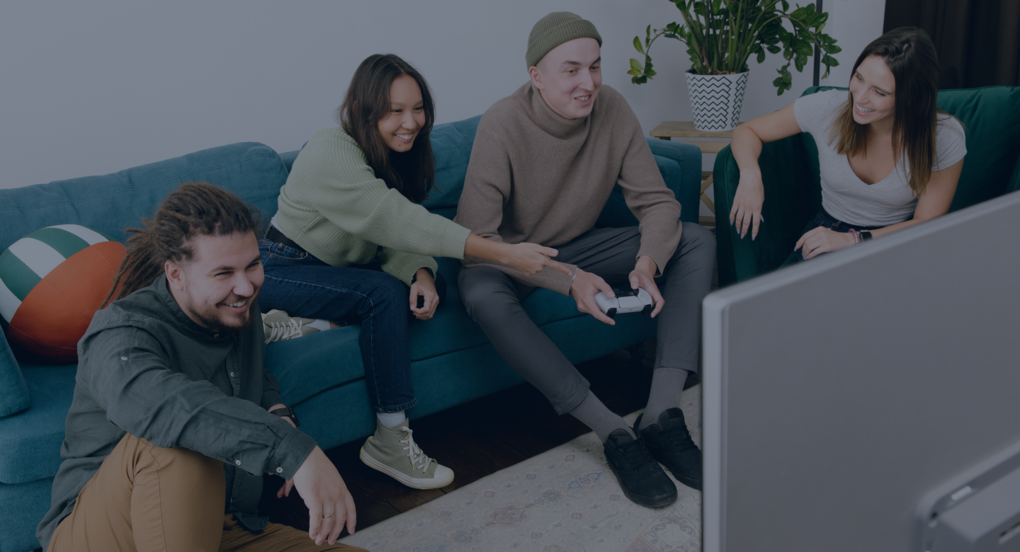 People are sitting on the couch and playing a video game console