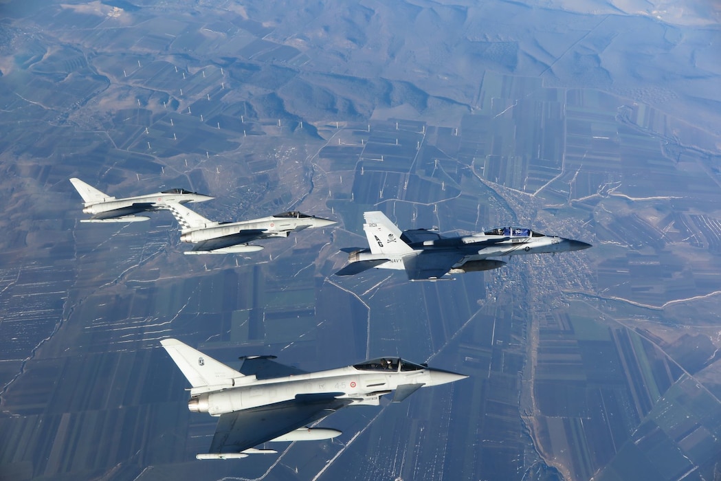 An F/A-18F Super Hornet from VFA-103 and Greek navy Typhoon aircraft fly over Romania.