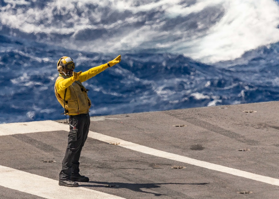 Aviation Boatswain's Mate (Handling) 1st Class Jose Mejiacastro, from Cabana, El Salvador, performs aircraft handling on the flight deck of the first-in-class aircraft carrier USS Gerald R. Ford (CVN 78), March 8, 2023.