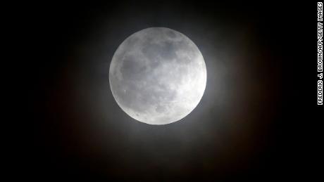 The last full moon of the decade, with a saffron-colored tinge, better known as the full &quot;Cold Moon&quot;, hovers over Los Angeles, California on December 11, 2019. (Photo by Frederic J. BROWN / AFP) (Photo by FREDERIC J. BROWN/AFP via Getty Images)