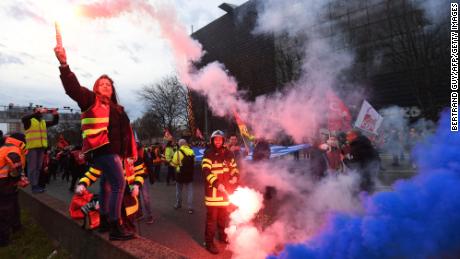 CGT unionists light flares on the ring road as they block the traffic to protest, a day after the French government pushed a pensions reform through parliament without a vote, using the article 49,3 of the constitution, in Paris on March 17, 2023. - French President faces intensified protests and accusations of anti-democratic behaviour after pushing through a contentious pension reform without a parliamentary vote. (Photo by BERTRAND GUAY / AFP) (Photo by BERTRAND GUAY/AFP via Getty Images)