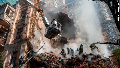 FILE - Firefighters work after a drone attack on buildings in Kyiv, Ukraine, on  Oct. 17, 2022. The Iranian-made drones that Russia sent slamming into central Kyiv this week have produced hand-wringing and consternation in Israel, complicating the country&#39;s balancing act between Russia and the West. (AP Photo/Roman Hrytsyna)