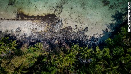 An oil slick from the sunken tanker MT Princess Empress along a shoreline on March 8, 2023, in Pola, Oriental Mindoro, Philippines. 