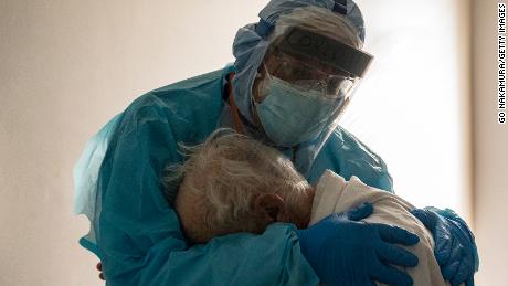 HOUSTON, TX - NOVEMBER 26: (EDITORIAL USE ONLY) Dr. Joseph Varon hugs and comforts a patient in the COVID-19 intensive care unit (ICU) during Thanksgiving at the United Memorial Medical Center on November 26, 2020 in Houston, Texas. According to reports, Texas has reached over 1,220,000 cases, including over 21,500 deaths.  (Photo by Go Nakamura/Getty Images)