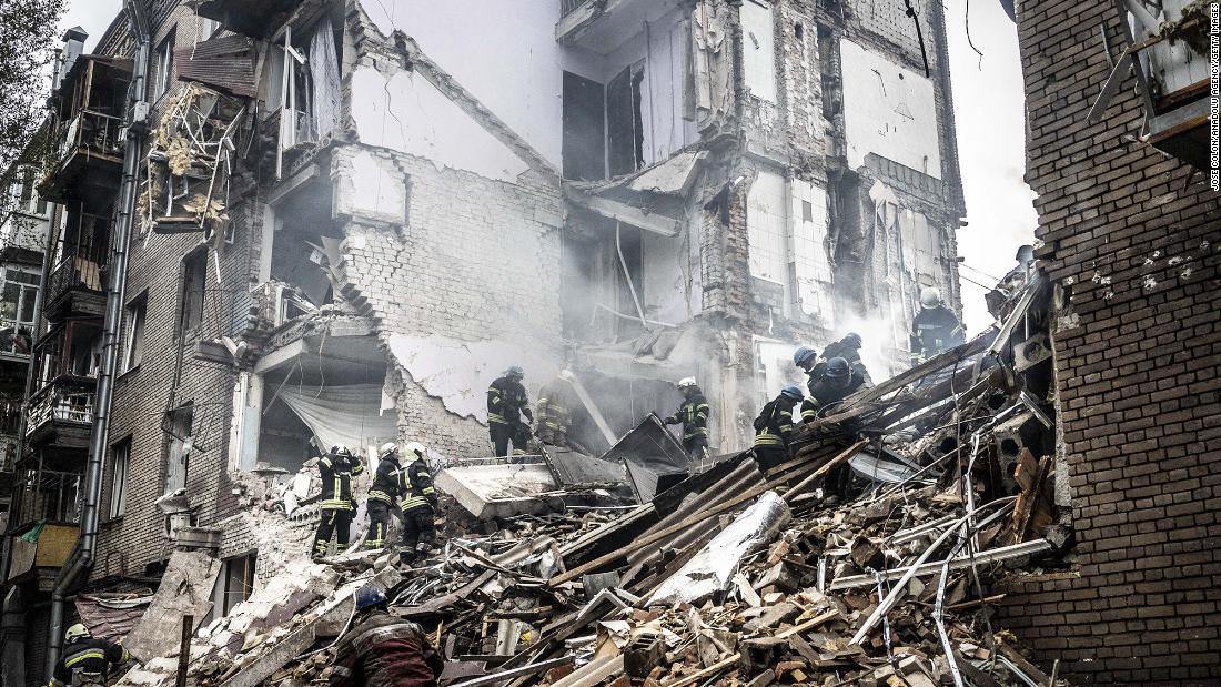 Firefighters conduct work on a damaged building after a Russian missile attack in Zaporizhzhia, Ukraine, on October 10.