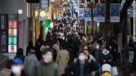 People walk along a street in the Omotesando area in Tokyo, Japan, on Friday, Dec. 9, 2022. 