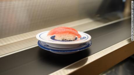 A plate of tuna sushi on a conveyor belt at Kura Sushi Inc.&#39;s Harajuku store in Tokyo, Japan, on Wednesday, Sept. 21, 2022. Over the years, some sushi chains have introduced more non-traditional options like fried chicken and sushi using spices and mayonnaise, the kind popular with younger eaters and tourists. Kura Sushi is even selling dessert crepes at its Harajuku store. Photographer: Akio Kon/Bloomberg