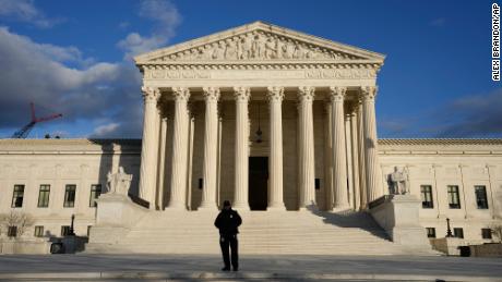 FILE - Security stands outside the U.S. Supreme Court, Jan. 20, 2023, in Washington. (AP Photo/Alex Brandon, File)