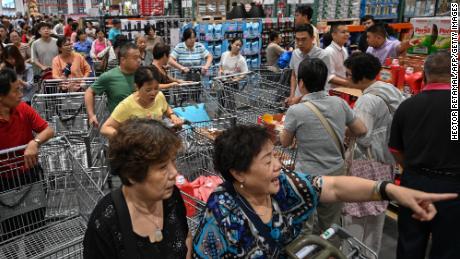 People visit the first Costco outlet in China, on the stores opening day in Shanghai on August 27, 2019. China has proved a brutal battleground for overseas food retailers in recent years, with many failing to understand consumer habits and tastes as well as local competitors building a stronger presence. 