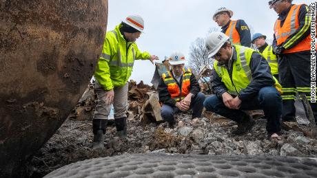 U.S. Secretary of Transportation Pete Buttigieg (2L) visits with Department of Transportation Investigators at the site of the derailment on February 23, 2023 in East Palestine, Ohio. 