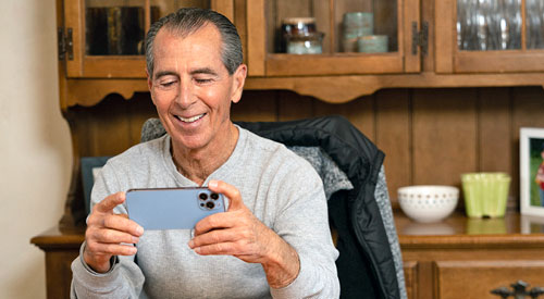 male veteran talking on video call, smiling