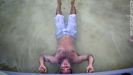 A man cools off in a fountain on 9 de Julio avenue in Buenos Aires, Argentina, on March 8, 2023.