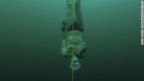 Czech freediver David Vencl dives to 52 metres under the ice of Lake Sils in one breath and wearing only a swimsuit in this picture taken from a video in Sils near St. Moritz, Switzerland March 14, 2023. David Vencl Organisation/Handout via REUTERS THIS IMAGE HAS BEEN SUPPLIED BY A THIRD PARTY. NO RESALES. NO ARCHIVES