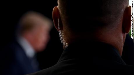 A secret service agent watches as US President Donald Trump speaks during a news conference in Bedminster, New Jersey, on August 7, 2020. (Photo by JIM WATSON / AFP) (Photo by JIM WATSON/AFP via Getty Images)