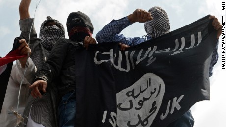 Kashmiri demonstrators hold up a flag of the Islamic State of Iraq and the Levant (ISIL) during a demonstration against Israeli military operations in Gaza, in downtown Srinagar on July 18, 2014. The death toll in Gaza hit 265 as Israel pressed a ground offensive on the 11th day of an assault aimed at stamping out rocket fire, medics said. AFP PHOTO/Tauseef MUSTAFA        (Photo credit should read TAUSEEF MUSTAFA/AFP/Getty Images)