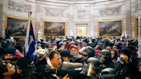 Police clash with rioters who breached security and entered the Capitol building in Washington DC, on January 6. 