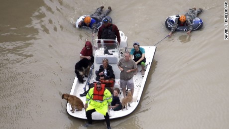 Evacuees make their way though floodwaters near the Addicks Reservoir as floodwaters from Tropical Storm Harvey rise Tuesday, Aug. 29, 2017, in Houston. (AP Photo/David J. Phillip)