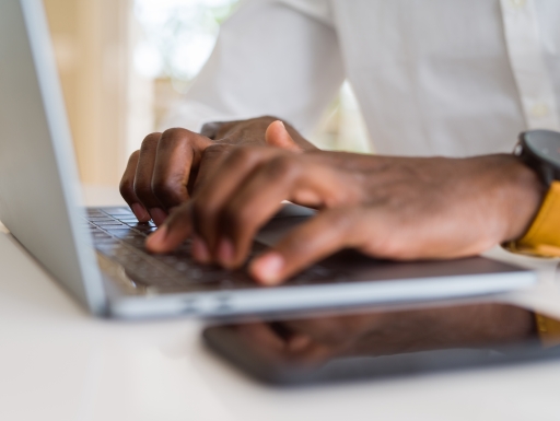 hands using keyboard of computer laptop