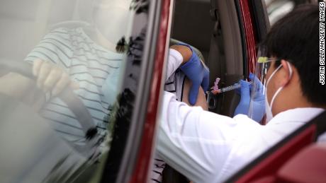 SANTA ROSA, CALIFORNIA - JANUARY 13: Safeway pharmacist Preston Young administers a Moderna COVID-19 vaccination during a drive-thru COVID-19 vaccination clinic at the Sonoma County Fairgrounds on January 13, 2021 in Santa Rosa, California. Sonoma County health workers received COVID-19 vaccinations during a drive-thru clinic that was hosted by Sonoma County and Safeway. (Photo by Justin Sullivan/Getty Images)