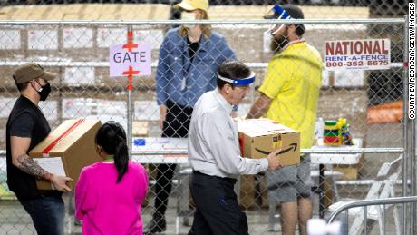 PHOENIX, AZ - MAY 01: Former Secretary of State Ken Bennett (right) works to move ballots from the 2020 general election at Veterans Memorial Coliseum on May 1, 2021 in Phoenix, Arizona. The Maricopa County ballot recount comes after two election audits found no evidence of widespread fraud in Arizona.  (Photo by Courtney Pedroza/Getty Images)