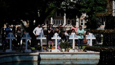 People pay their respects at a memorial site for the victims killed in this week&#39;s elementary school shooting in Uvalde, Texas, Thursday, May 26, 2022. 