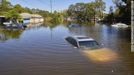 Vehicles and homes submerged in water in a flooded neighborhood following Hurricane Ian in Orlando, Florida, US, on Friday, Sept. 30, 2022. Two million electricity customers in Florida remained without power Friday morning, according to the tracking site poweroutage.us. Photographer: Brian Carlson/Bloomberg via Getty Images