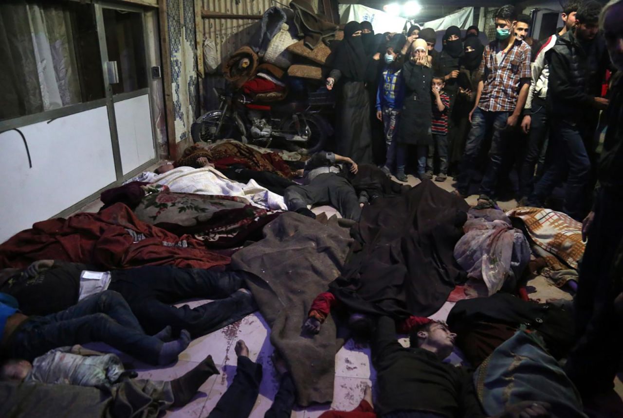 Bodies lie on the ground in the rebel-held city of Douma, Syria, on April 8, 2018. <a href="https://www.cnn.com/2018/04/11/middleeast/syria-chemical-attack-500-affected-who-intl/index.html" target="_blank">According to activist groups,</a> helicopters dropped barrel bombs filled with toxic gas on Douma, which has been the focus of a renewed government offensive that launched in mid-February. The Syrian government and its key ally, Russia, vehemently denied involvement and accused rebel groups of fabricating the attack to hinder the army's advances and provoke international military intervention.