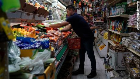 A person arranges groceries in El Progreso Market in the Mount Pleasant neighborhood of Washington, D.C., U.S., August 19, 2022. 