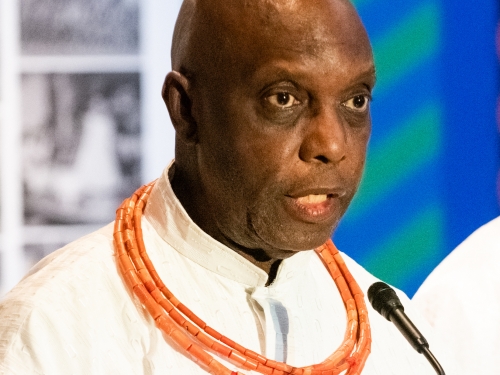 Man speaks at podium microphone