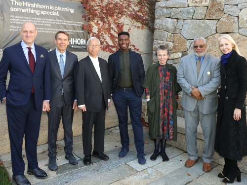 Group of people stand together outside