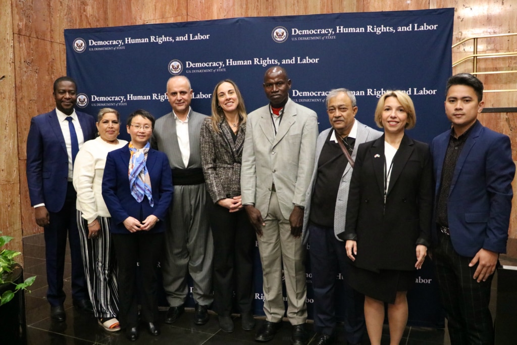 Bureau of Democracy, Human Rights, and Labor Acting Assistant Secretary Erin Barclay stands alongside awardees and those accepting awards on awardees’ behalf at the Global Human Rights Defender Awards ceremony.
