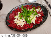 Carpaccio with cheese and arugula served on plate. Стоковое фото, фотограф Яков Филимонов / Фотобанк Лори