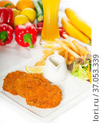 Classic breaded Milanese veal cutlets with french fries , vegetables... Стоковое фото, фотограф Francesco Perre / easy Fotostock / Фотобанк Лори