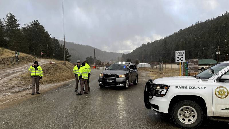 Sheriff deputies block a road in the town of Bailey, Colo., where authorities found an...