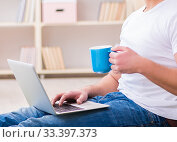 Man working on laptop at home on carpet floor. Стоковое фото, фотограф Elnur / Фотобанк Лори