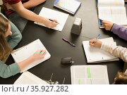 Four students working in a classroom. Стоковое фото, фотограф Shannon Fagan / Ingram Publishing / Фотобанк Лори