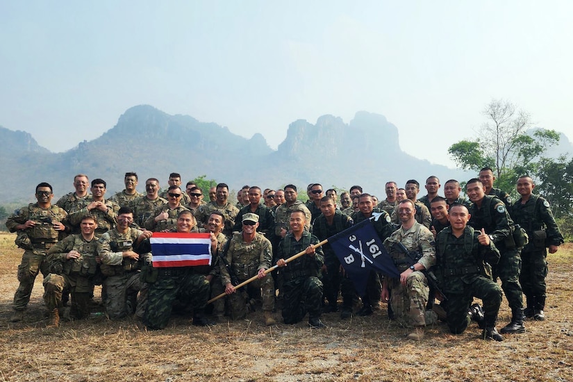 A large group of soldiers pose for a photo.