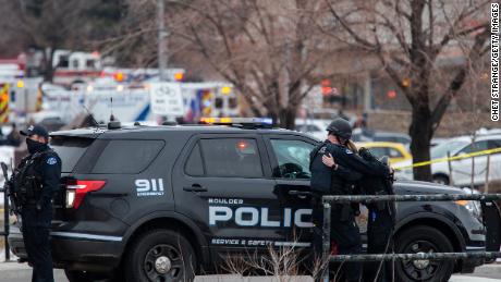 BOULDER, CO - MARCH 22:  Two police officers embrace after a gunman opened fire at a King Soopers grocery store on March 22, 2021 in Boulder, Colorado. Dozens of police responded to the afternoon shooting in which at least one witness described three people who appeared to be wounded, according to published reports.  (Photo by Chet Strange/Getty Images)