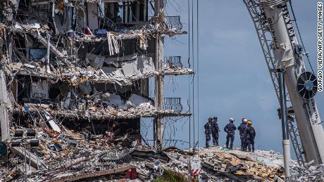 TOPSHOT - Members of the South Florida Urban Search and Rescue team look for possible survivors in the partially collapsed 12-story Champlain Towers South condo building on June 27, 2021 in Surfside, Florida. - The death toll after the collapse of a Florida apartment tower has risen to nine, the local mayor said on June 27, 2021, more than three days after the building pancaked as residents slept. &quot;We were able to recover four additional bodies in the rubble... So I am confirming today that the death toll is at nine,&quot; Miami-Dade County mayor Daniella Levine Cava told reporters in Surfside, near Miami Beach, adding that one victim had died in hospital. &quot;We&#39;ve identified four of the victims and notified next of kin.&quot; (Photo by Giorgio Viera / AFP) (Photo by GIORGIO VIERA/AFP via Getty Images)