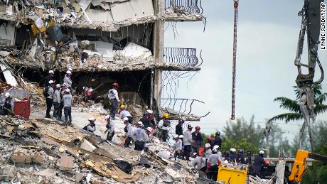 Rescue workers search in the rubble at the Champlain Towers South condominium, Monday, June 28, 2021, in the Surfside area of Miami. Many people are still unaccounted for after the building partially collapsed last Thursday. (AP Photo/Lynne Sladky)