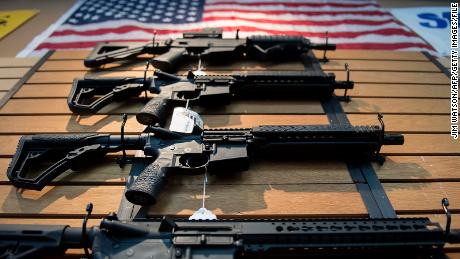 Assault rifles hang on the wall for sale at Blue Ridge Arsenal in Chantilly, Virginia, on October 6, 2017.