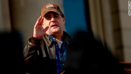 Patrick Colbeck, an election integrity activist and former state senator, speaks as conservative activists who are demanding another investigation into former President Donald Trump&#39;s 2020 election loss rally on Tuesday, Feb. 8, 2022, outside the Michigan Capitol in Lansing. Colbeck had called for &quot;thousands of patriots&quot; to fill the building and hear him speak on the House floor. He told an audience of around 80 attendees that plans changed, and speeches were held outside with Republican candidates for governor and other offices. (Jake May/The Flint Journal via AP)